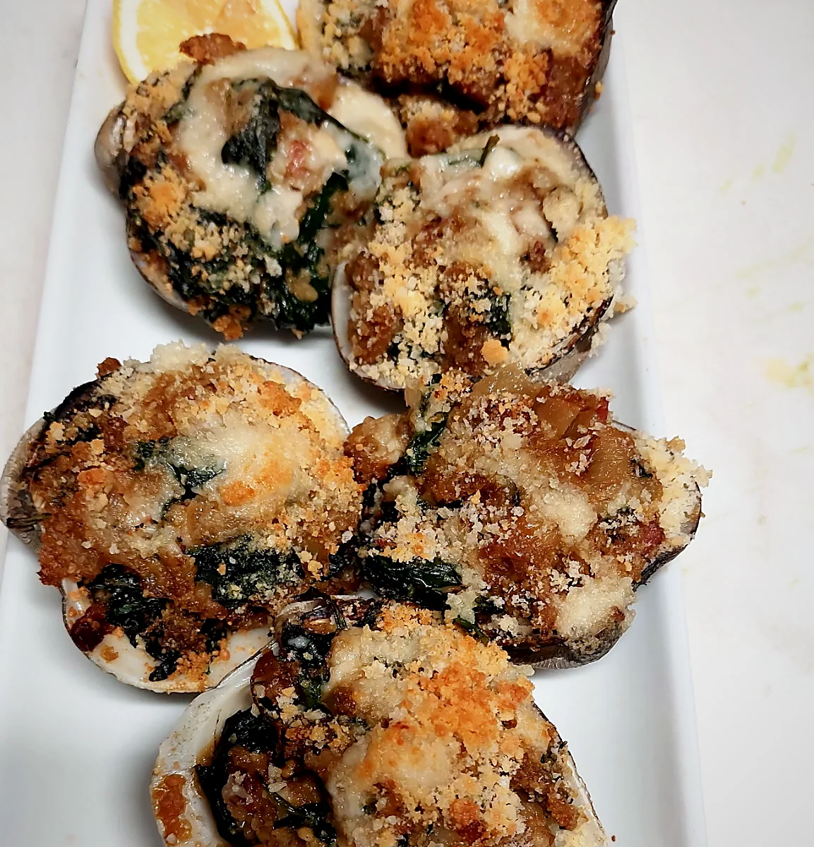 Baked stuffed clams with spinach and a golden breadcrumb crust