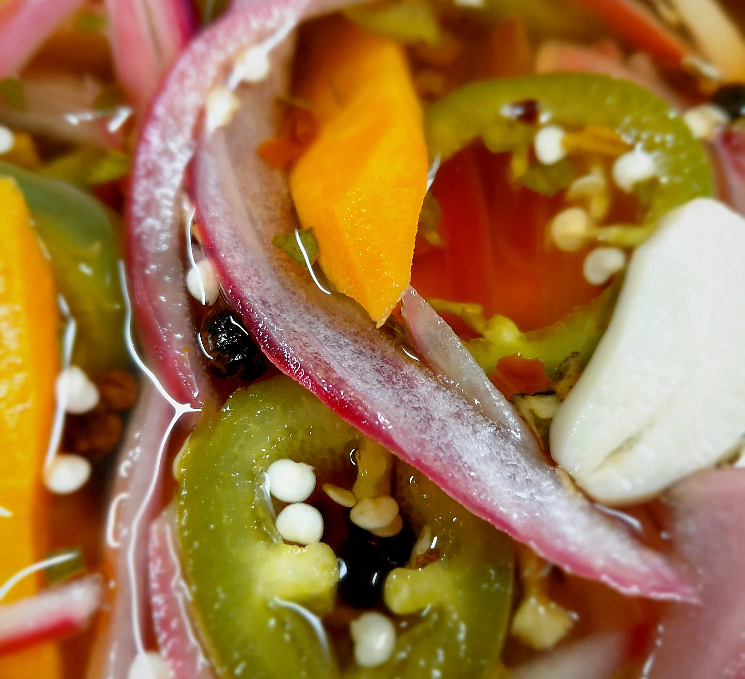 Close-up of pickled red onion, jalapeno and carrot